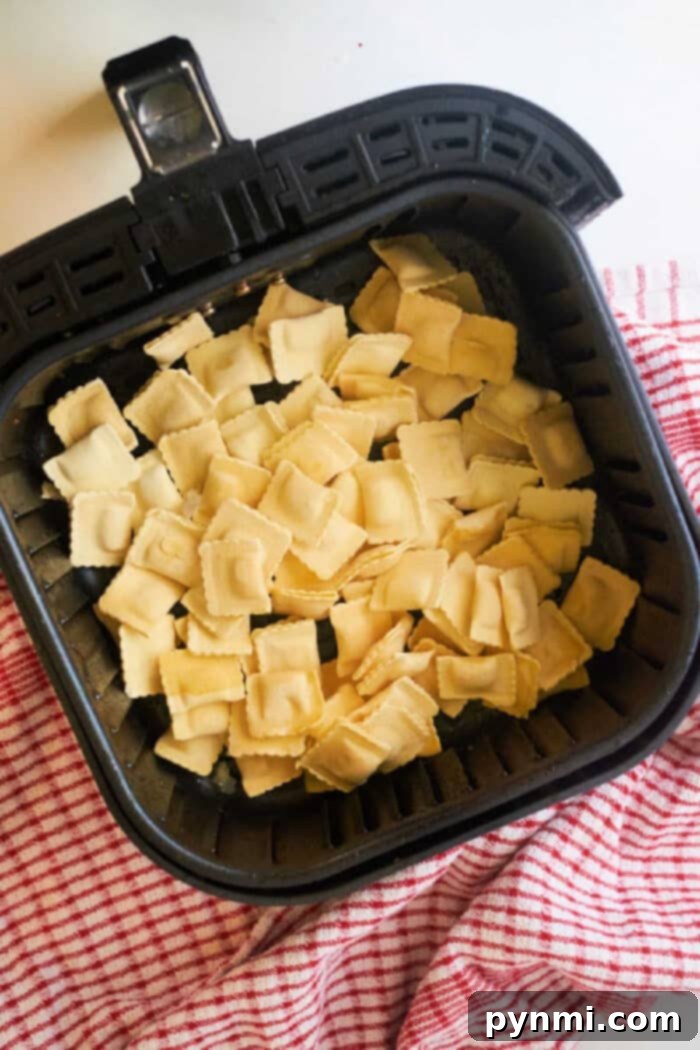 Frozen ravioli in air fryer, cooked to a light crisp and served on a white plate