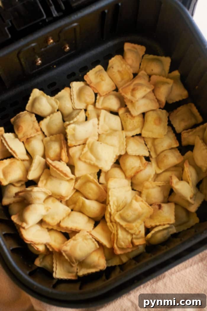 Air fried frozen ravioli served in a bowl with a side of marinara sauce