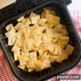 A dish of perfectly air fried frozen ravioli, crispy and golden