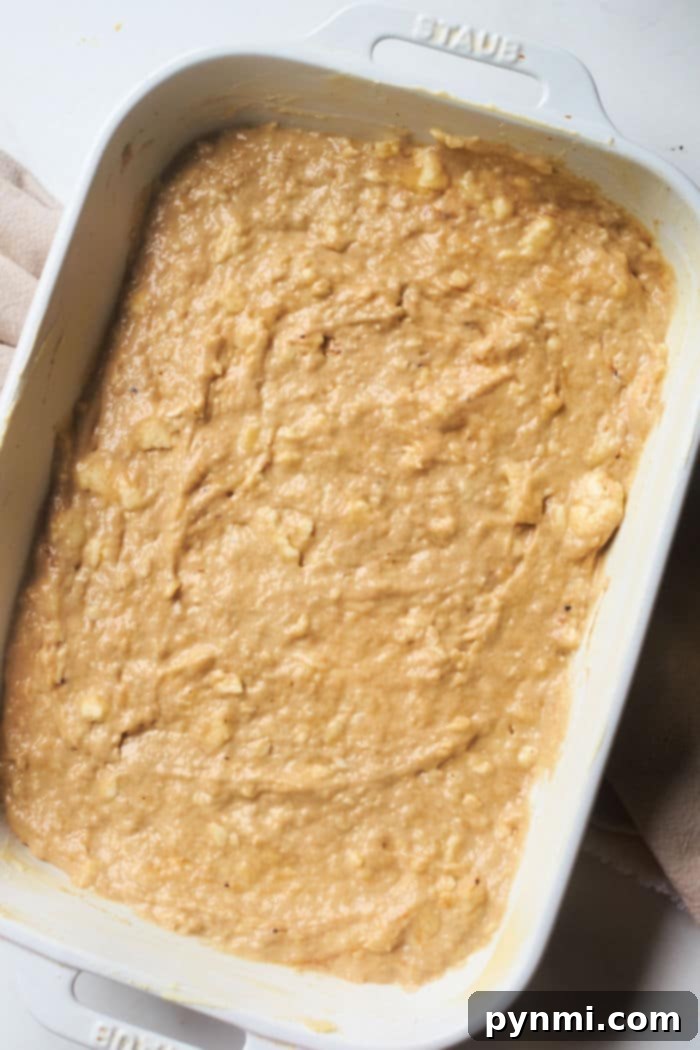 Ultimate Banana Streusel Coffee Cake 4 Banana bread coffee cake baking in a 9x13 pan, showing the golden streusel topping.