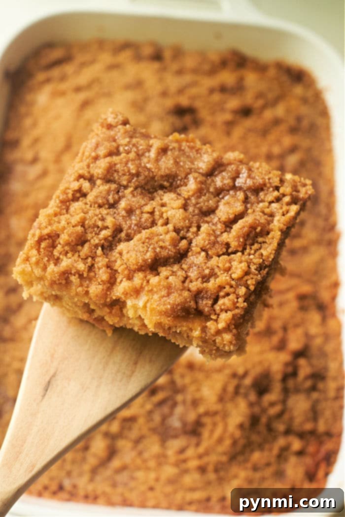 Ultimate Banana Streusel Coffee Cake 5 A slice of banana coffee cake on a plate, showing its moist interior and crumble.