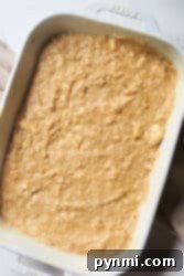 Banana coffee cake batter in a white baking dish, ready to be baked.