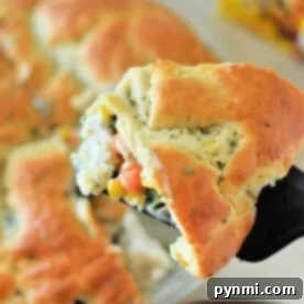 Chicken Pot Pie Shortcut 7 A slice of savory pie with a golden crust, filled with vegetables, emerges from the dish—a delightful Bisquick Pot Pie treat.