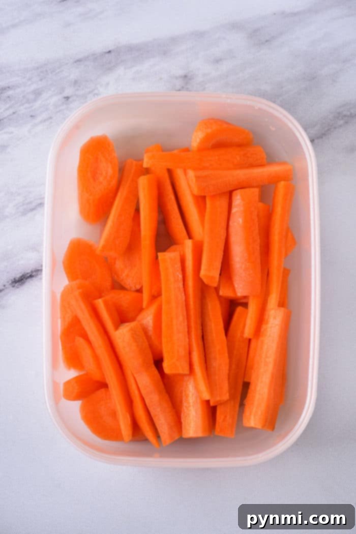 Effortless Microwave Carrots 4 How to Cook Carrots in Microwave: A close-up of colorful carrots, peeled and sliced, ready for microwave cooking.