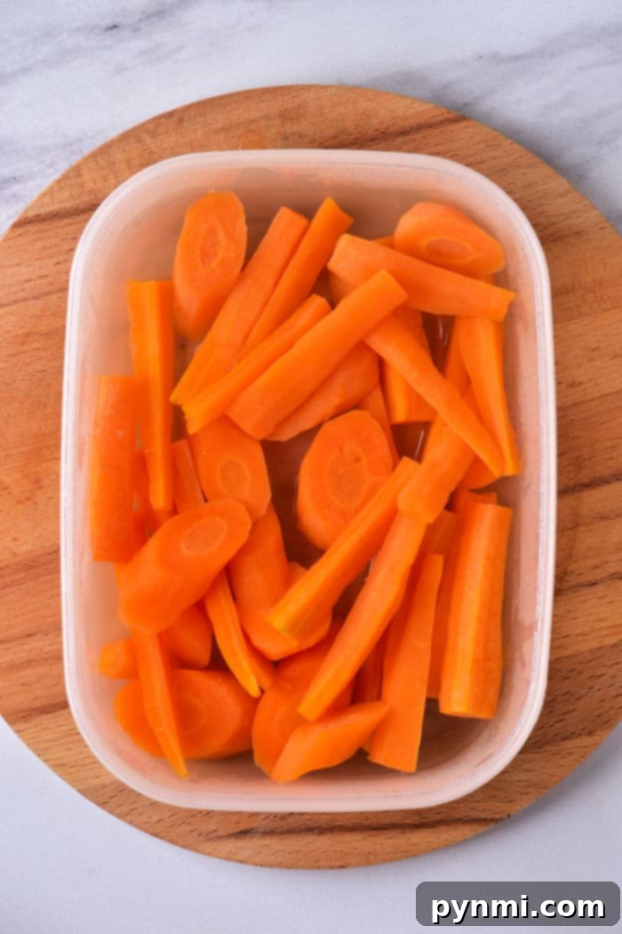 Effortless Microwave Carrots 5 Quick Way to Steam Carrots: A bowl of microwaved carrots, perfectly steamed and seasoned, demonstrating the ease of preparation.