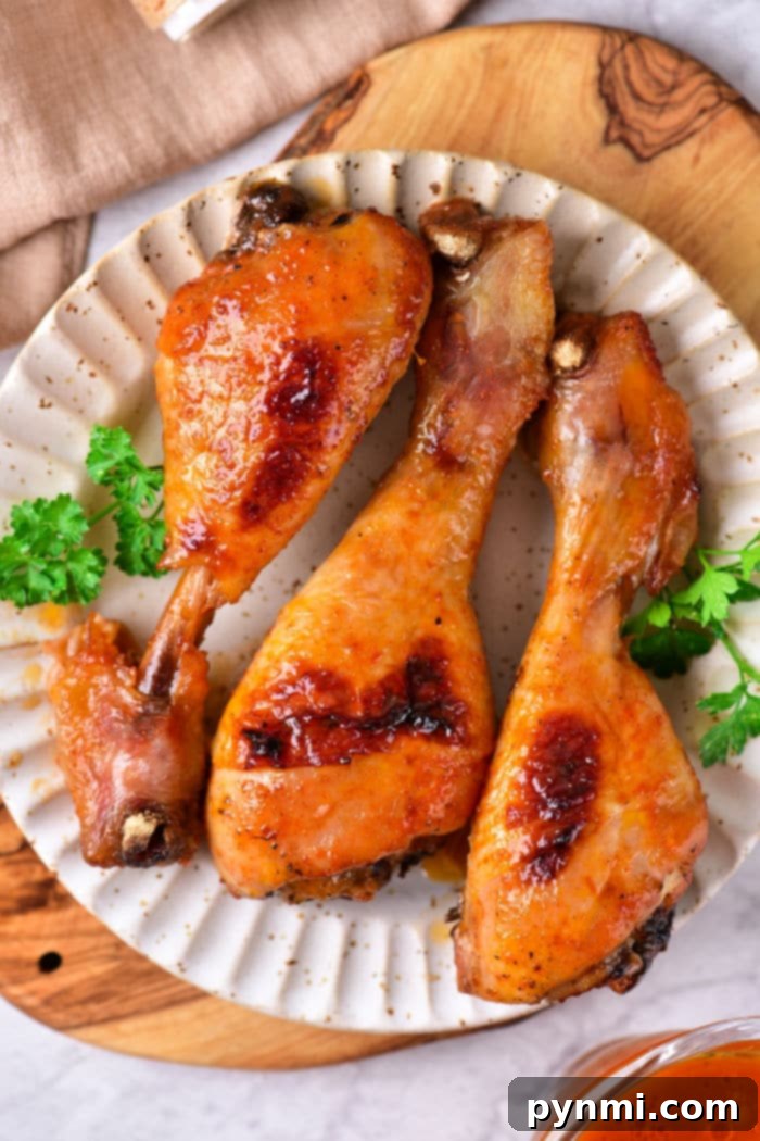 Optimal Bake Time for Chicken Drumsticks at 400F 6 baked chicken drumsticks are artfully arranged on a plate with a fresh parsley garnish, all set atop a rustic wooden board. Wondering how long to bake chicken drumsticks at 400 degrees? These tips ensure each bite is perfectly cooked and bursting with flavor.