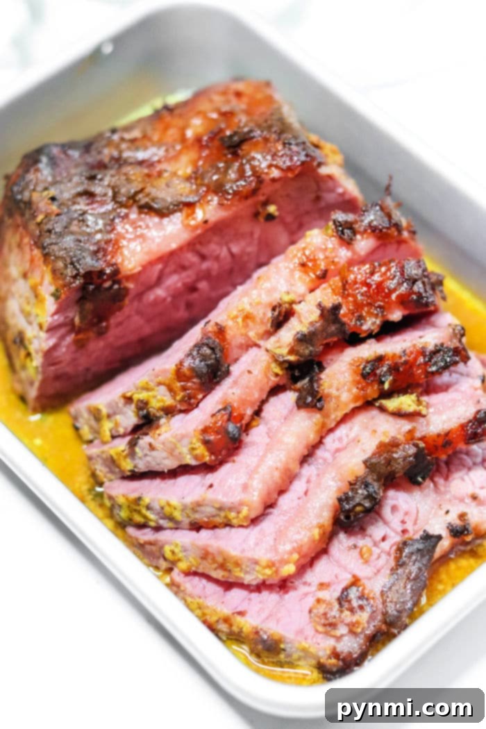 Air Fried Corned Beef Perfection 11 Air Fryer Corned Beef - A large, perfectly cooked corned beef brisket, glistening on a serving platter.