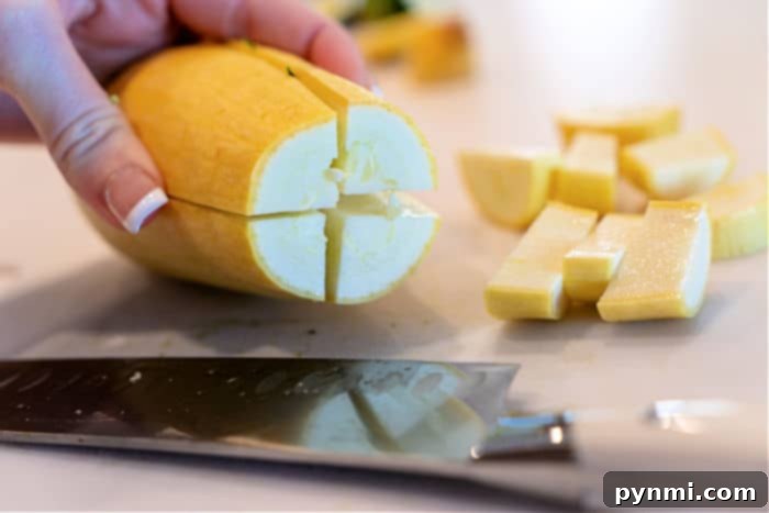 Yellow Squash and Zucchini Recipe ingredients in a bowl with olive oil and seasonings