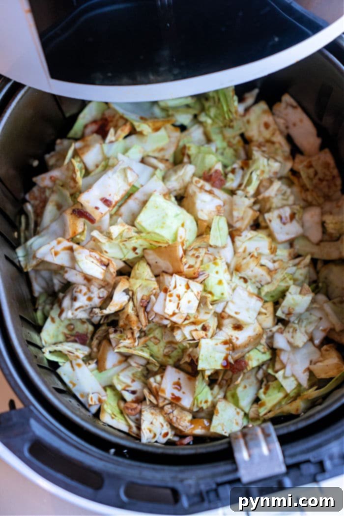 Crispy Air Fryer Cabbage 7 A vibrant bowl of Air Fryer Fried Cabbage, garnished with fresh herbs, ready to be served as a delicious side dish.
