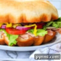 Bundt Witch 8 Learn how to make a bundtwich: a large sandwich with turkey, lettuce, tomato, red onion, and peppers, all perfectly nestled on a round bun. Serve it beautifully presented on a plate for the ultimate feast.