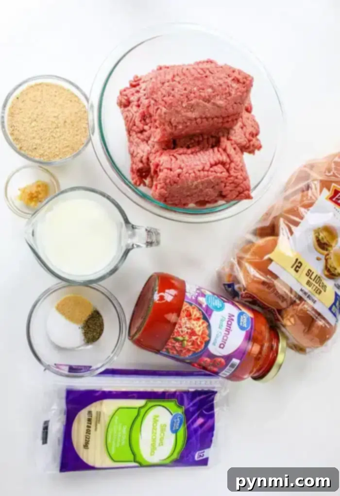 Whip Up Perfect Stovetop Meatballs 3 On a white surface, ground beef rests beside slider buns, marinara sauce, and sliced mozzarella cheese. Accompanied by breadcrumbs and small bowls of minced garlic and seasoning, a cup of milk completes the setup for learning how to cook meatballs on the stovetop.