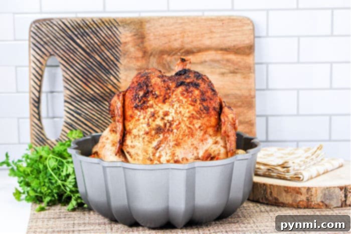 Crispy Oven Rotisserie Chicken 6 Whole roasted Bundt pan chicken cooling on a rack