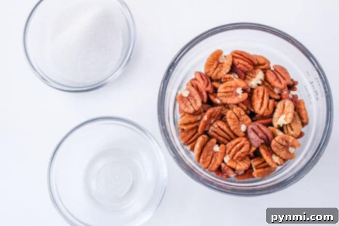 Quick Candied Pecans - A close-up shot of perfectly coated candied pecans cooling on parchment paper.