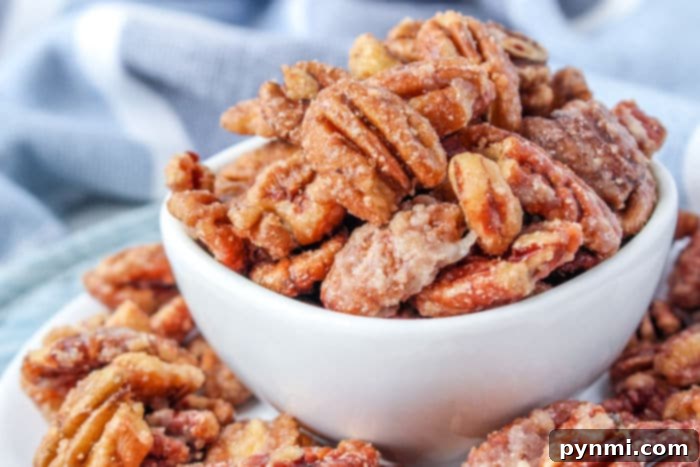 Candied Pecans No Egg Stovetop - A batch of eggless candied pecans beautifully arranged on a white background.