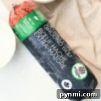 A package of frozen extra-lean ground beef sits invitingly on a cloth, framed by tempting cheese in the background. Its a perfect choice for those wondering how to cook frozen ground beef into a delicious meal.