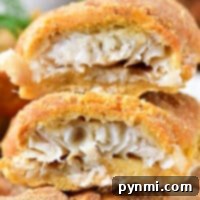 Close-up of a beer-battered, air-fried roll filled with shredded fish, shown cut in half.