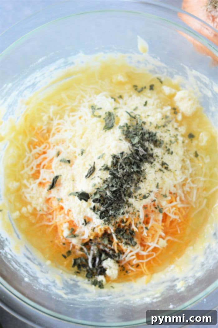 Close-up of a freshly baked squash quiche, highlighting the vibrant colors and textures.