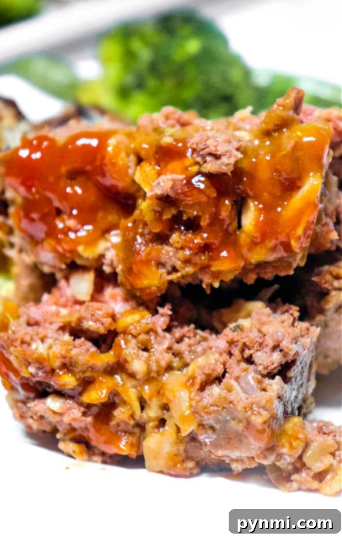 Juicy Meatloaf Without Breadcrumbs 7 Close-up of a slice of gluten-free meatloaf made with oats, showing its moist texture.
