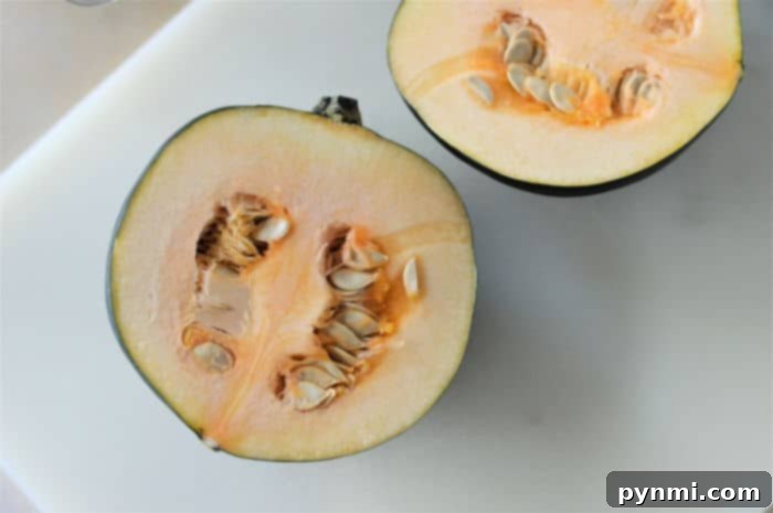 Speedy Microwave Acorn Squash 3 Close-up of a halved acorn squash ready for microwave cooking, showcasing its smooth texture and rich color, perfect for an easy side dish.