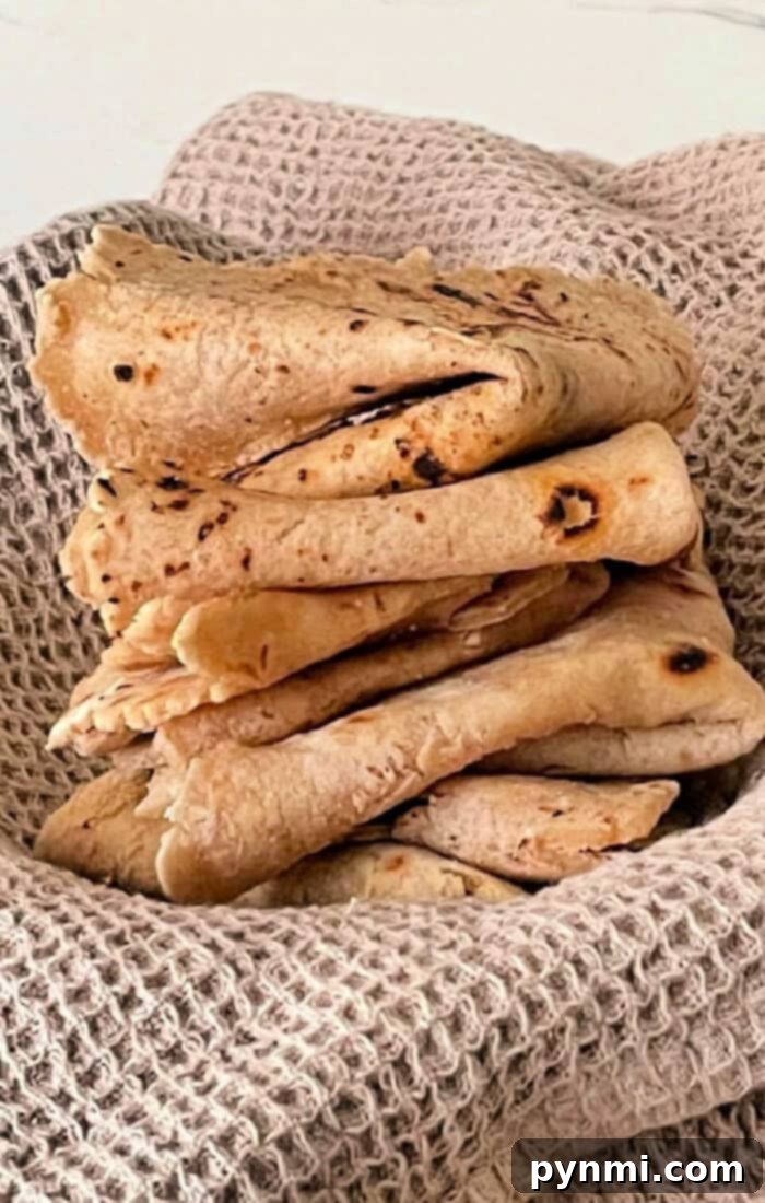 Mastering Roti at Home 2 How to Make Roti Bread - Freshly cooked, round roti flatbread resting on a plate, ready to be served.