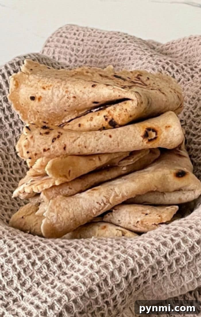 Mastering Roti at Home 8 Roti vs. Naan - A side-by-side comparison of different Indian flatbreads, highlighting their unique textures and appearance.