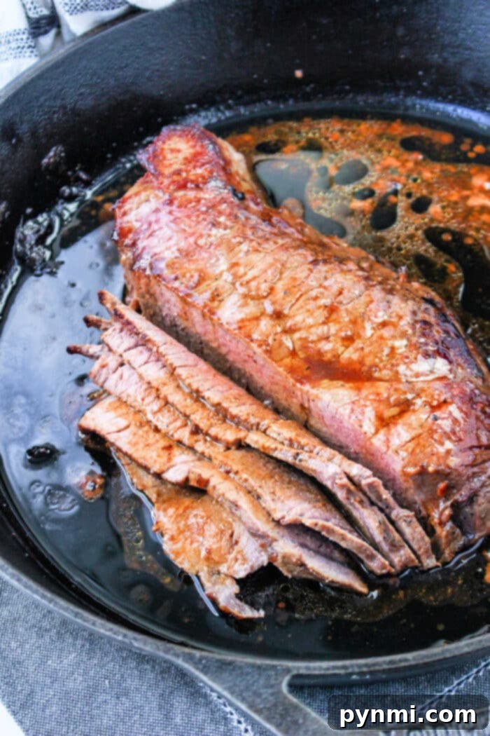Cast Iron Seared Flank Steak 6 Perfectly cooked flank steak, thinly sliced against the grain, ready to be served.