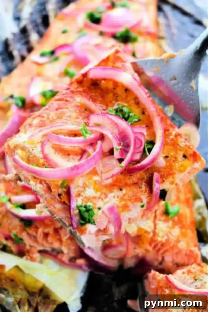 A final close-up of the perfectly baked salmon, garnished with fresh herbs and citrus, ready to be enjoyed. It represents the successful outcome of baking salmon at 400 degrees to perfection.