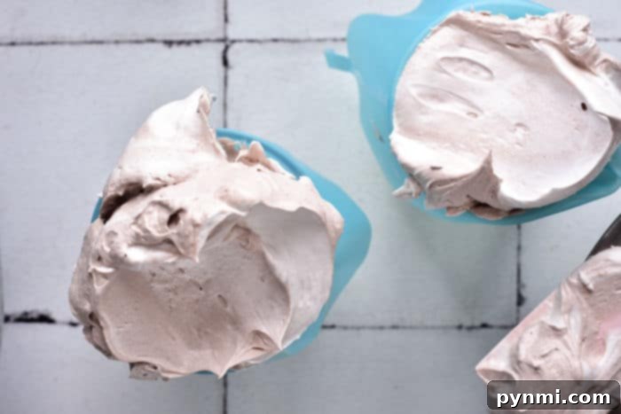 Close-up of three bowls filled with fluffy whipped meringue, each with unique toppings. One bowl evokes the tangy delight of lemon meringue pie, another the sweet comfort of strawberry shortcake, and a third awaits a new flavor adventure.