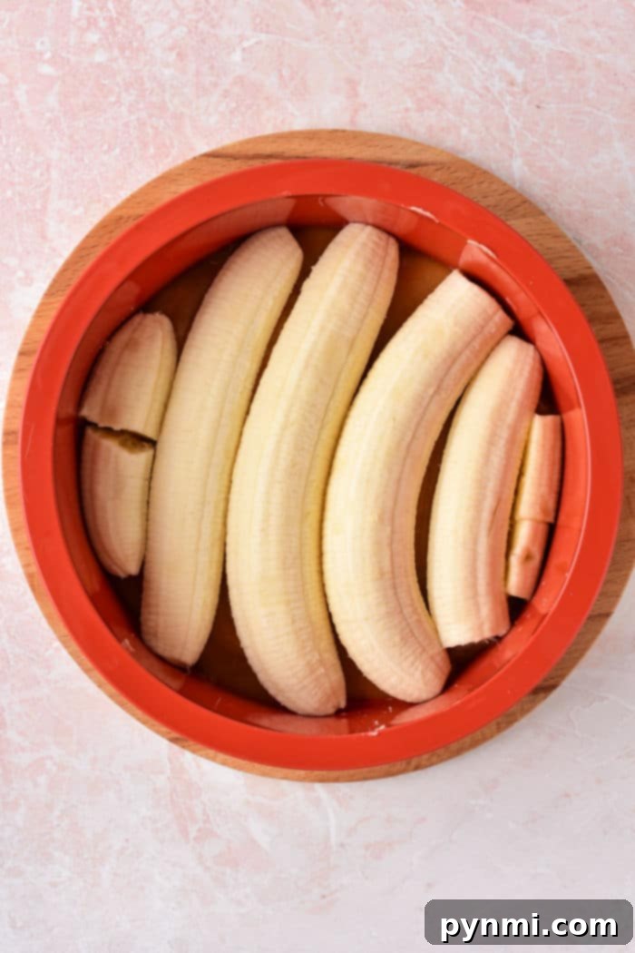 Golden Caramel Banana Flip Cake 4 A slice of upside down banana cake on a plate, showing the soft cake and golden bananas.