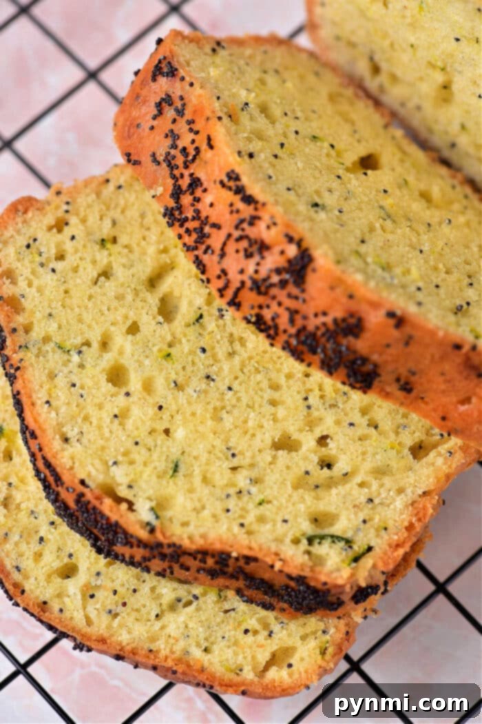 Zesty Lemon Zucchini Loaf 7 Sliced lemon zucchini poppy seed bread ready to be enjoyed, showcasing its moist texture.