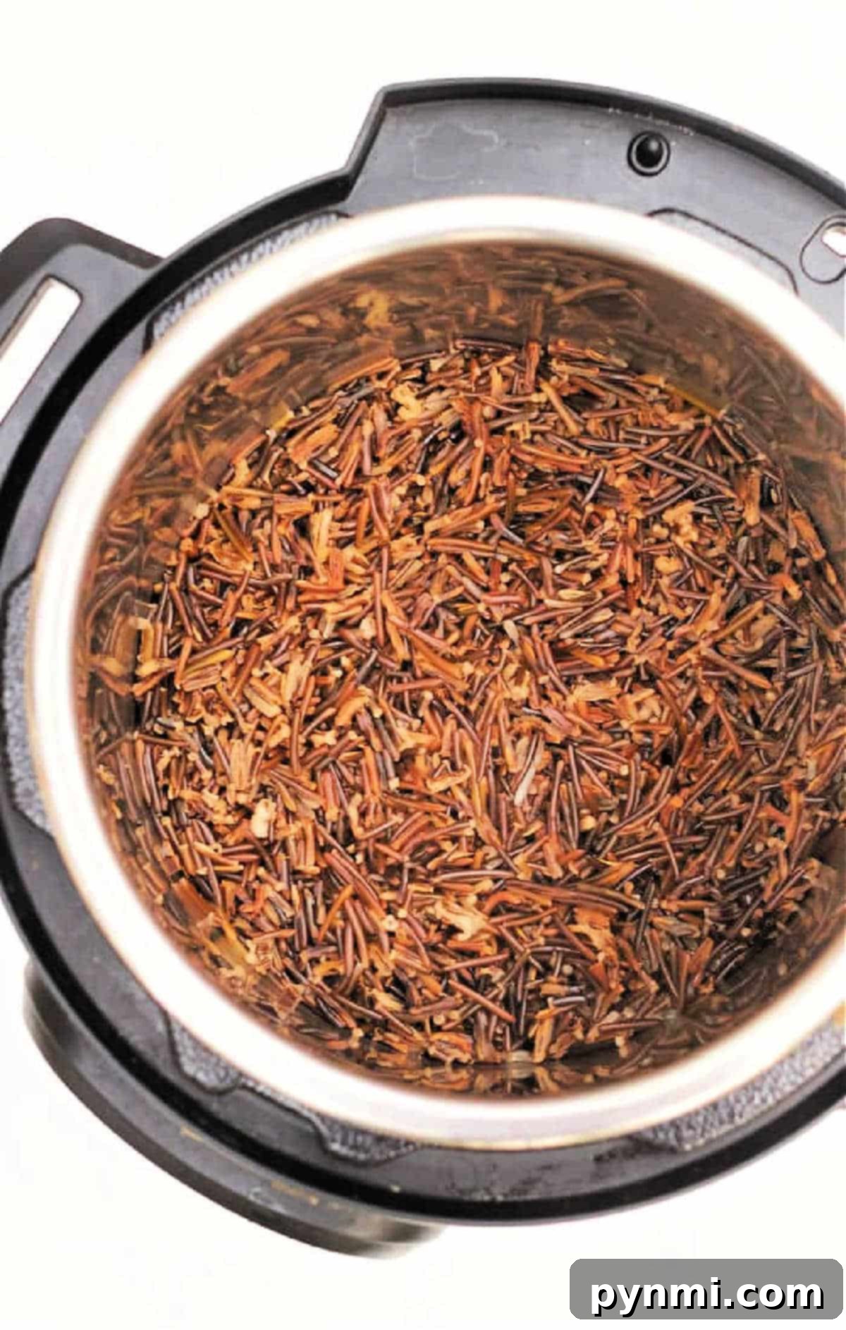 Instant Pot Black Rice Made Easy 6 Cooked wild rice and black rice inside an Instant Pot, viewed from above on a white background, highlighting the fluffy texture.