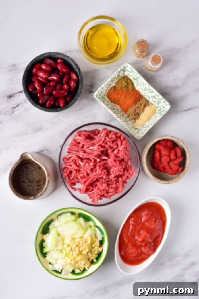 Le Creuset Dutch Oven Chili Recipe bubbling on the stove, showcasing its rich texture.