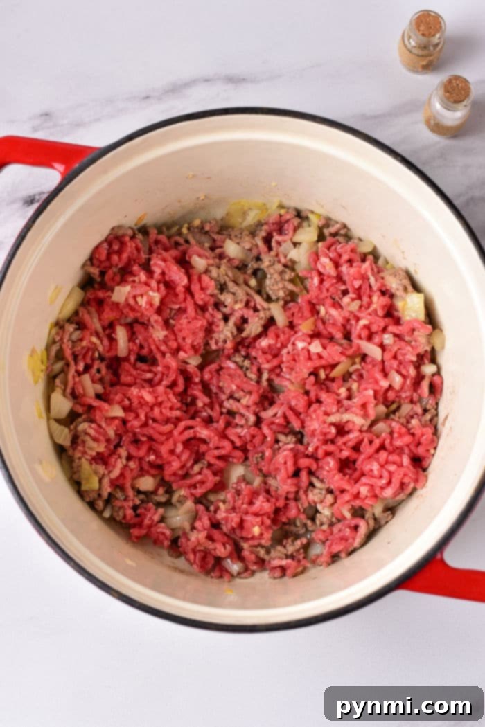 Easy Chili Recipe Stovetop bubbling away in a red Dutch oven.