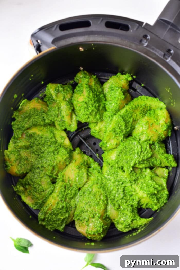 Crispy Air-Fried Pesto Chicken 6 Ninja Foodi Pesto Chicken cooking in the air fryer basket.