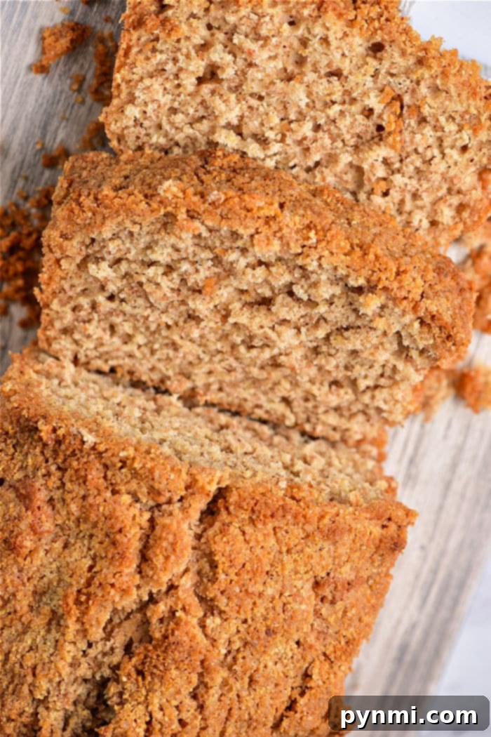 A sliced loaf of healthy coffee cake loaf rests on a wooden surface, effortlessly combining the comforting flavors of a healthy coffee cake, ready to be served.