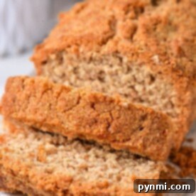 Sliced healthy coffee cake, rests on a wooden board, crumbs artfully scattered around.