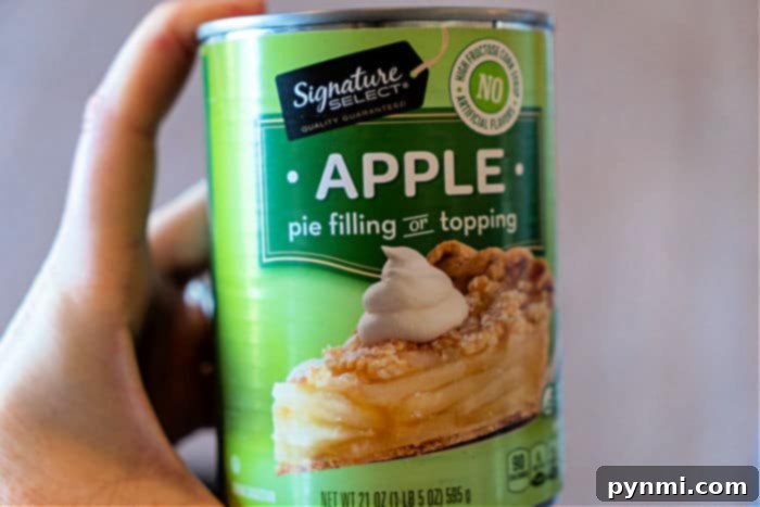 Easiest Pie with Pie Filling - A freshly baked pie featuring a golden pour-over crust, bubbling with fruit filling, ready to be scooped.