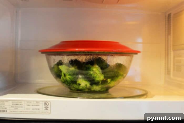 A vibrant bowl of microwaved broccoli seasoned and ready to serve as a delicious side dish.