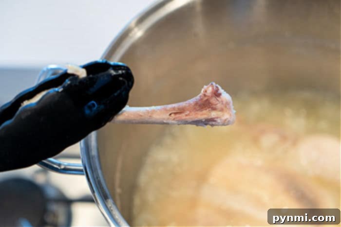 Achieving Tender Whole Chicken: The Ideal Boiling Time 6 Checking for doneness: The leg bone slides out easily when the chicken is perfectly boiled.