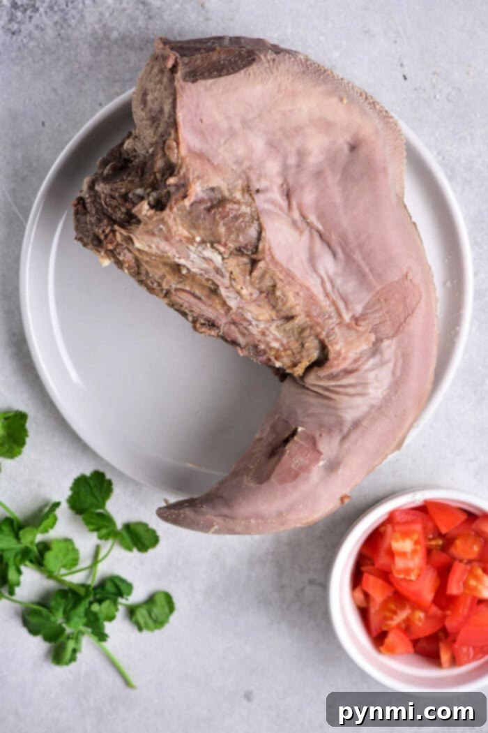 Lengua Tacos 4 Cooked beef tongue after boiling and peeling, ready for slicing.
