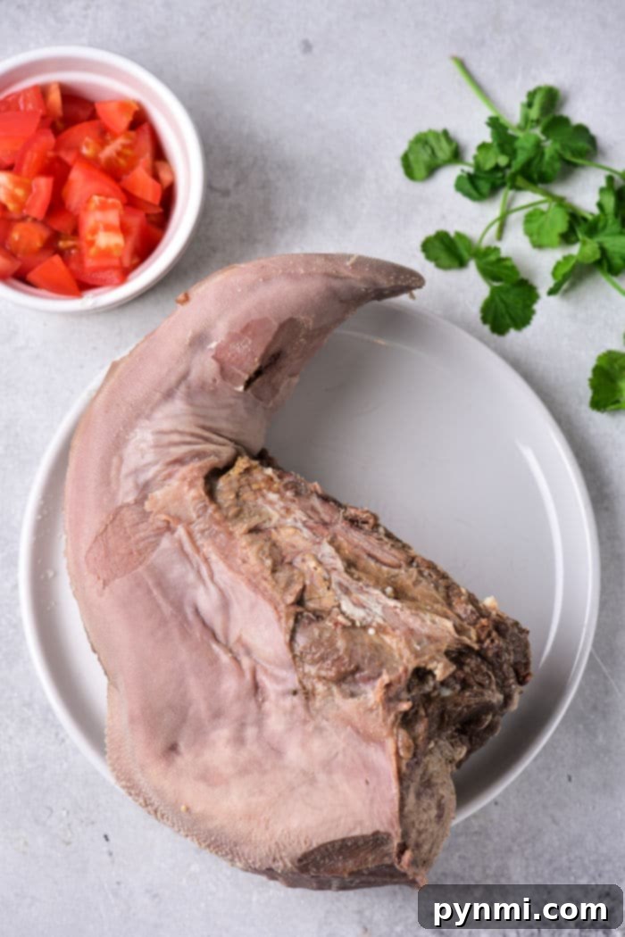 Cooked cow tongue in a pot with vegetables