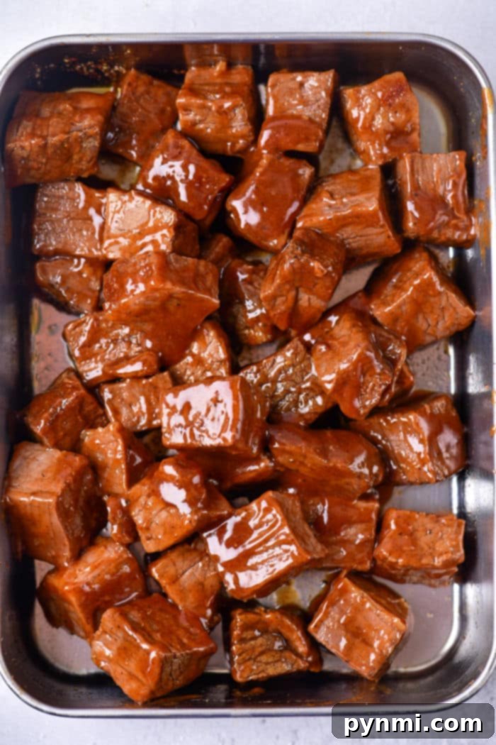 Smoked Chuck Burnt Ends 6 Burnt Ends in Oven, glistening with BBQ sauce