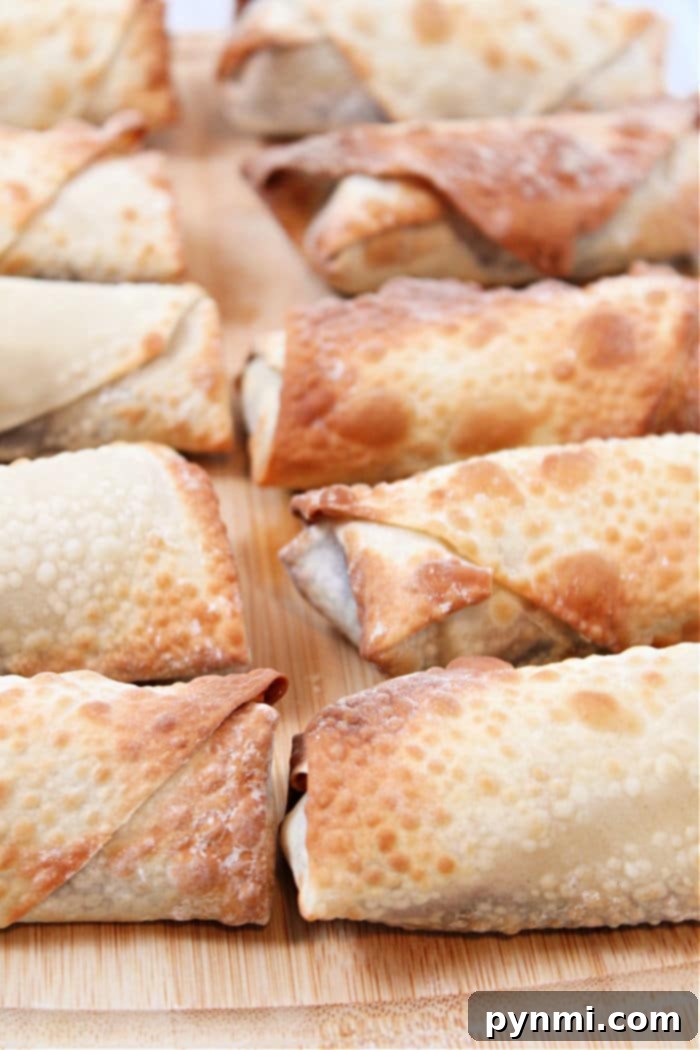 A vibrant display of fresh apples, brown sugar, cinnamon sticks, and egg roll wrappers, essential ingredients for making delicious Air Fryer Apple Pie Egg Rolls.