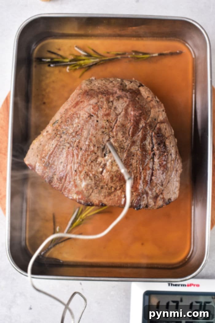 The Ultimate Melt-in-Your-Mouth Roast Beef 5 Baked Roast Beef - A full roast beef ready to be carved, showcasing its beautiful crust.
