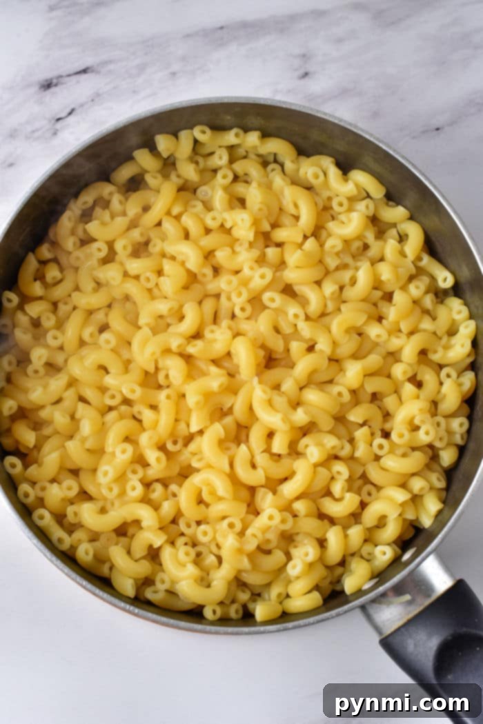 Decadent Heavy Cream Mac and Cheese 4 Creamy Baked Mac and Cheese with a golden crust, served in a white baking dish.