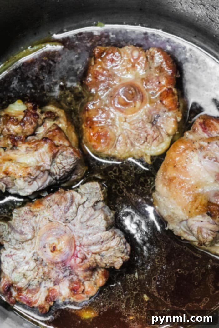 Slow-Cooked Oxtail and Rice 4 Pot of simmering oxtails with rice and vegetables, emitting steam and rich aromas