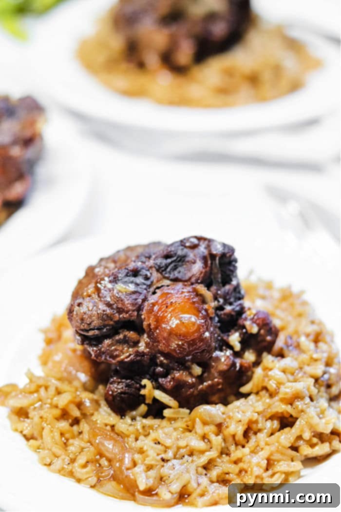 Slow-Cooked Oxtail and Rice 6 A serving of oxtails, rice, and green peas, beautifully plated for a comforting meal