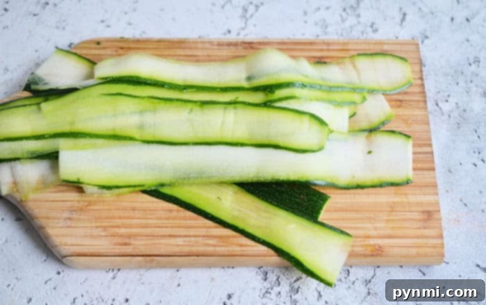 Sunny Zucchini Nests 3 Freshly sliced zucchini on a cutting board, ready for use in a healthy recipe, emphasizing its versatility and vibrant green color.