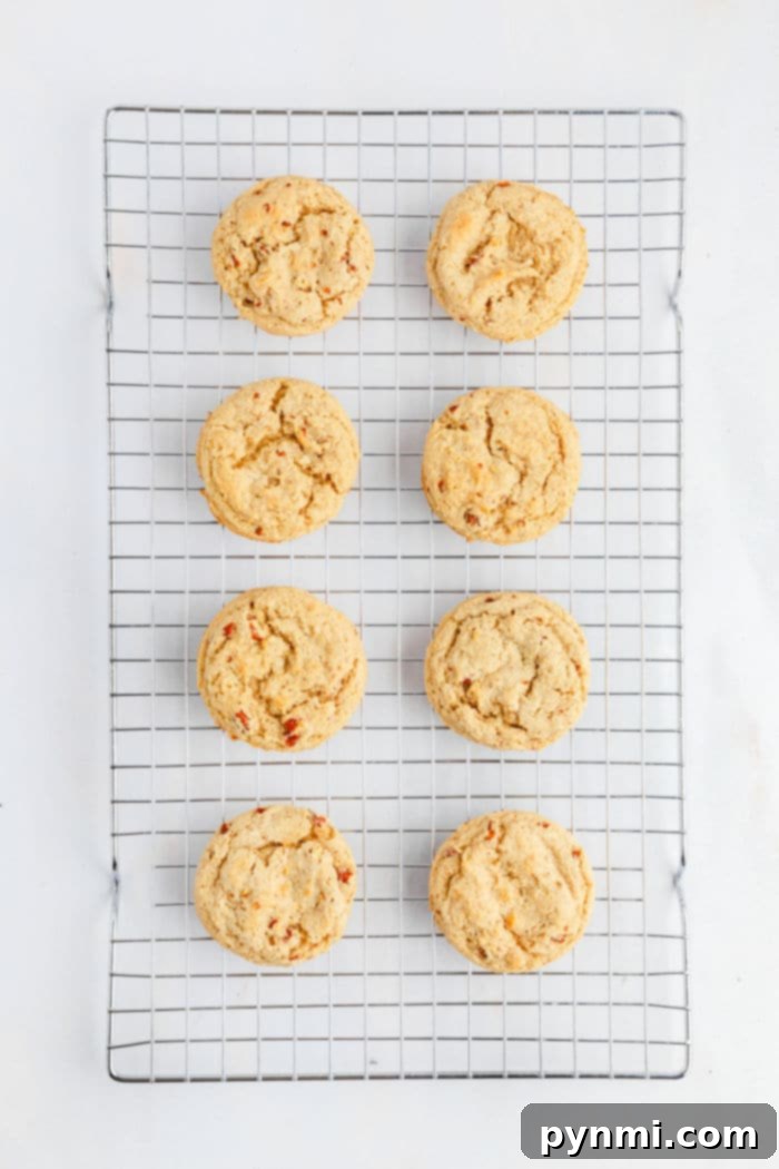 Buttery Pecan Cookie Bliss 5 Eight butter pecan Cookies cooling on a wire rack, arranged in two neat columns on a white background.