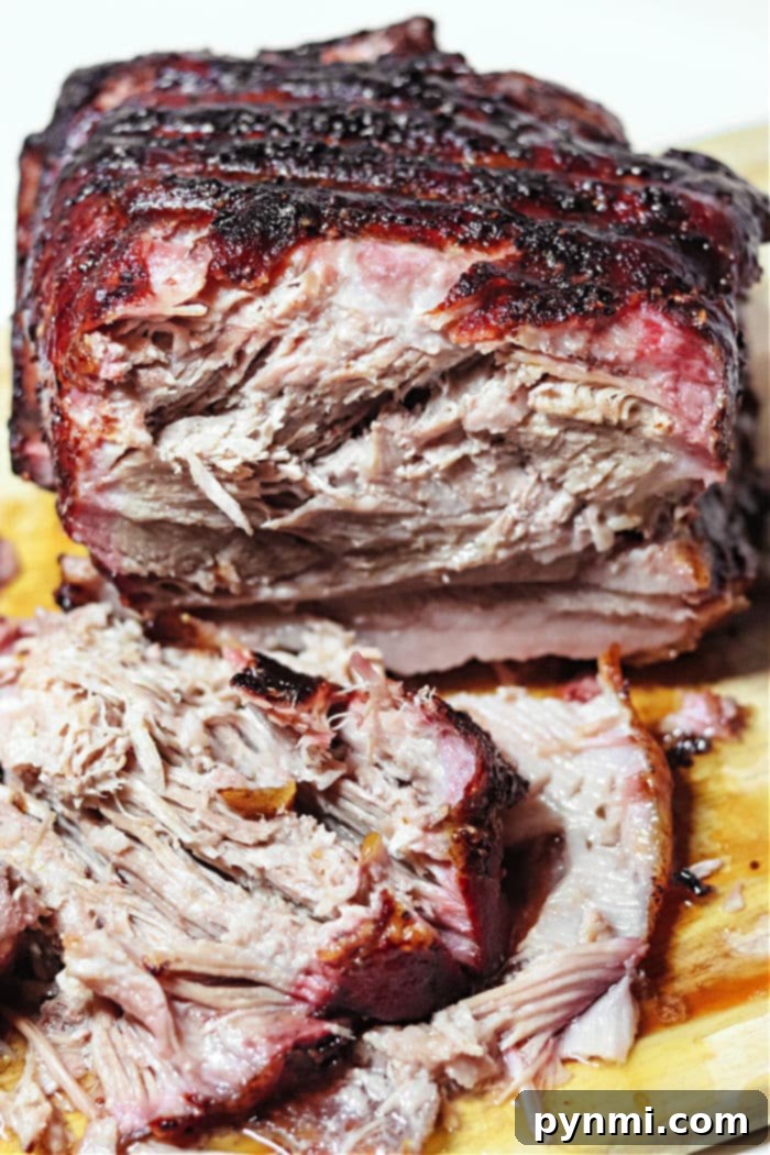 Slow-Smoked Pork Perfection 7 Large, succulent smoked pork roast shredded and ready for serving, perfect for pulled pork sandwiches or tacos.